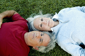 Couple looking up on grass
